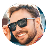 Smiling man with a beard wearing sunglasses