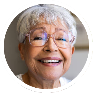 Smiling older woman with white hair and glasses