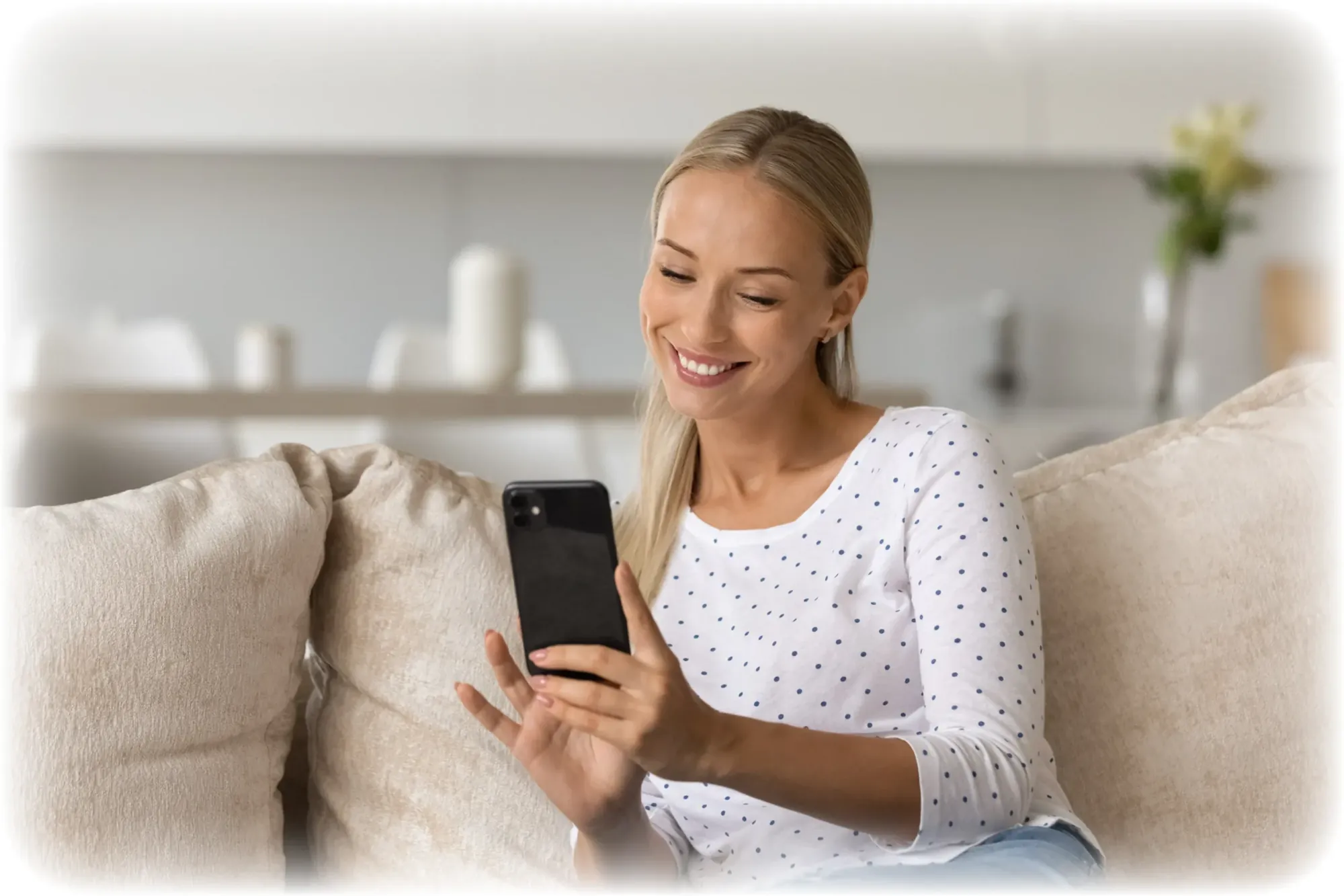 Woman on a sofa using the Membrance app on her phone