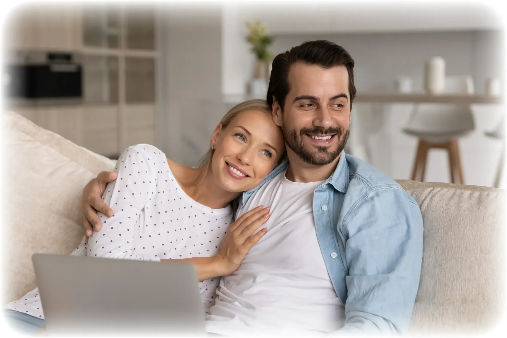 Couple on a sofa recording a message together on a phone