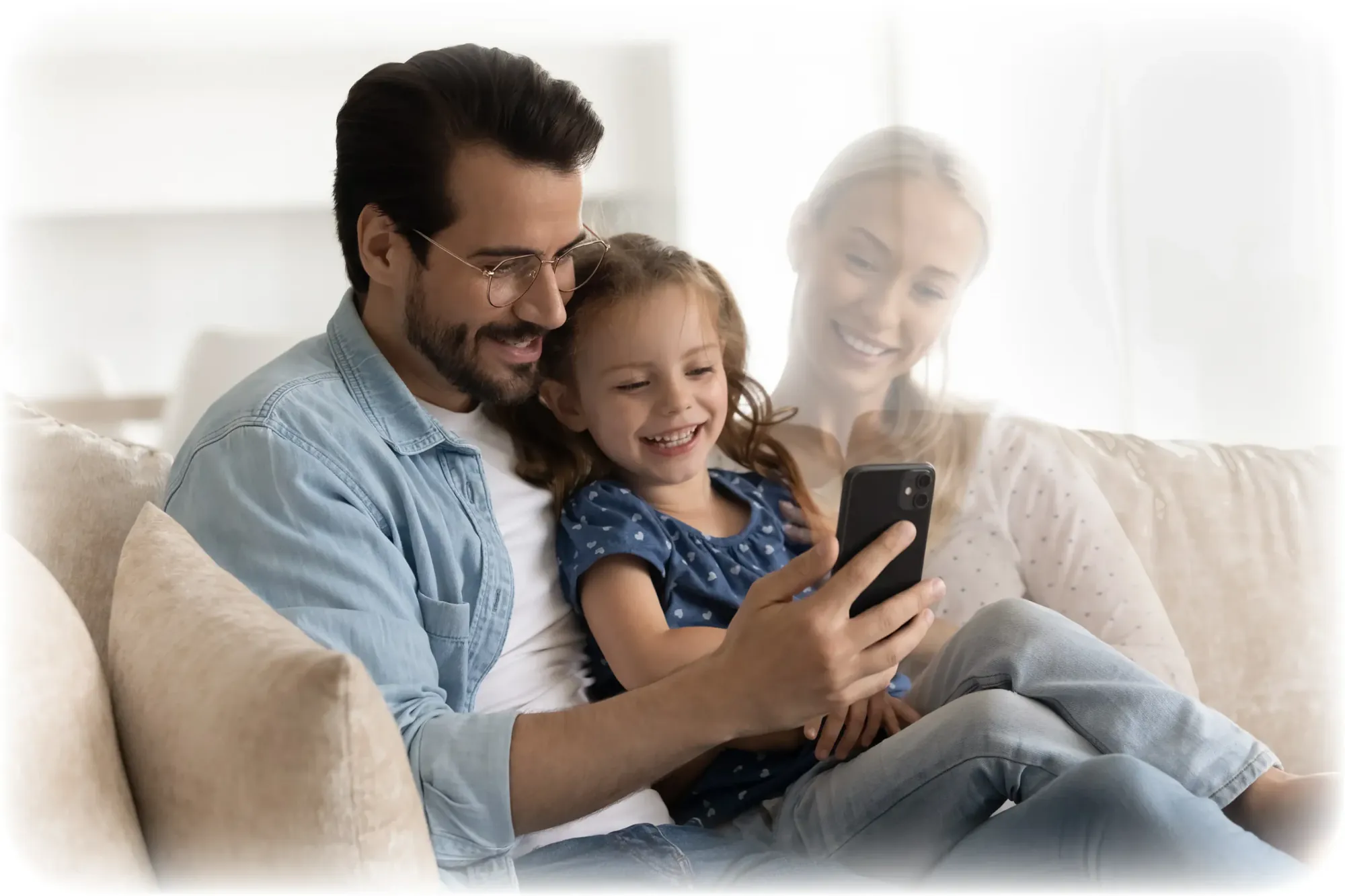 Father and daughter watching a video message on a phone